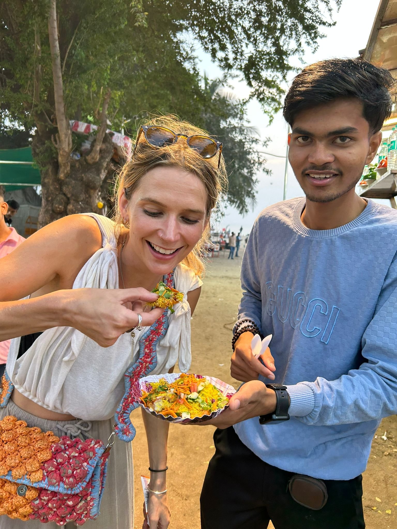 A guest trying street food on a guided tour in Mumbai