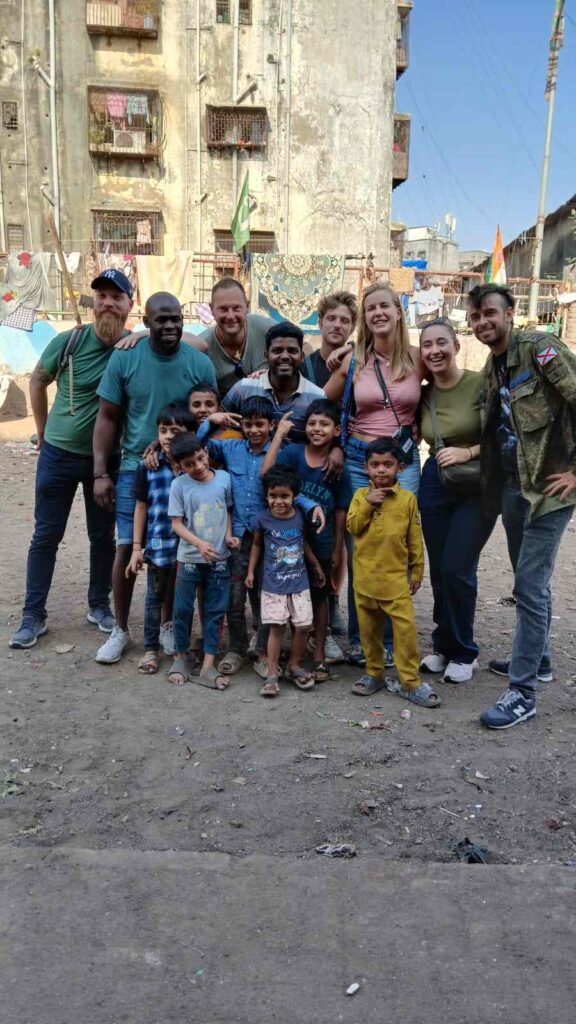 A Mumbai Experiences guide walking with visitors in Dharavi