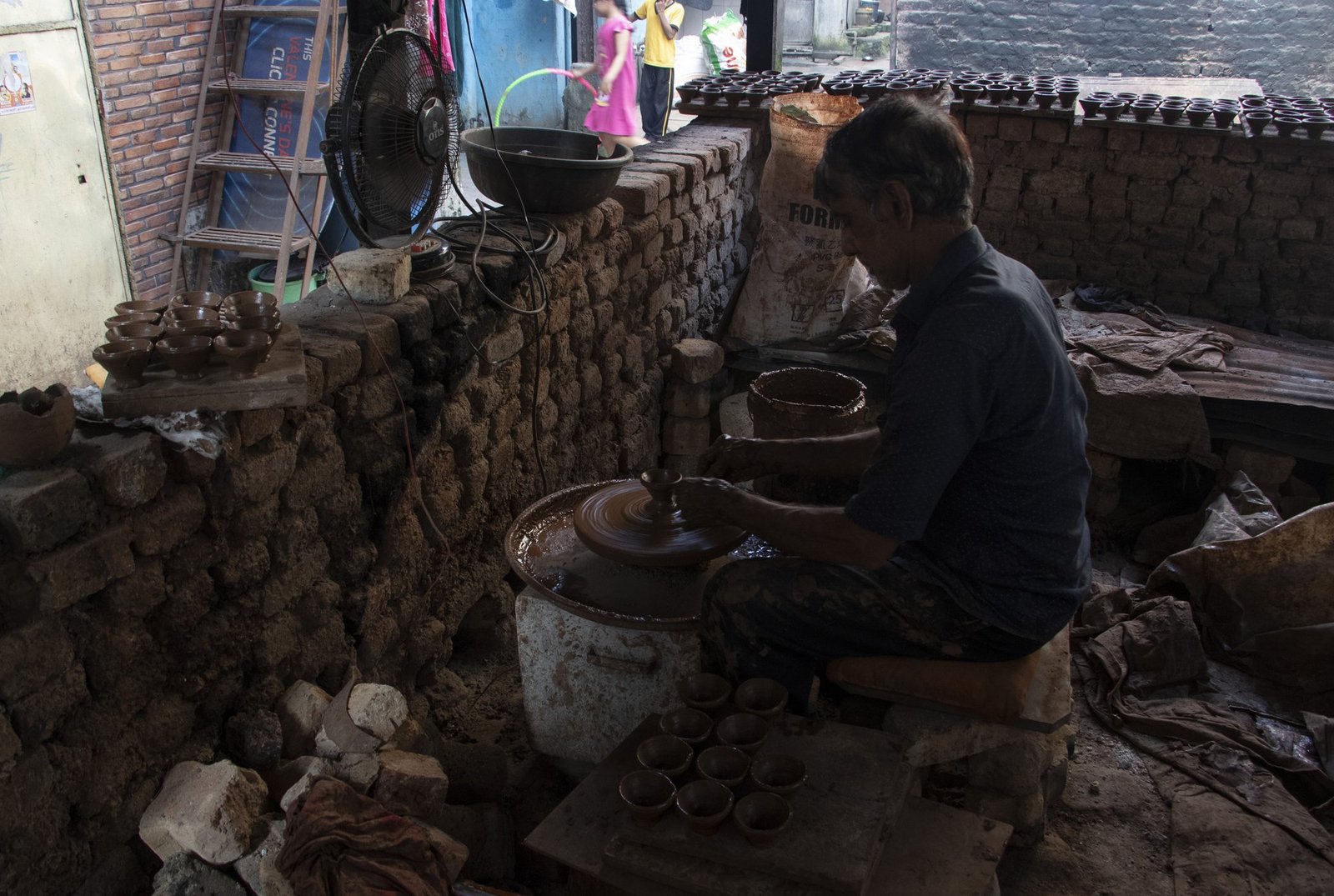 A potter at his wheel in Kumbharwada, the pottery quarter of Dharavi